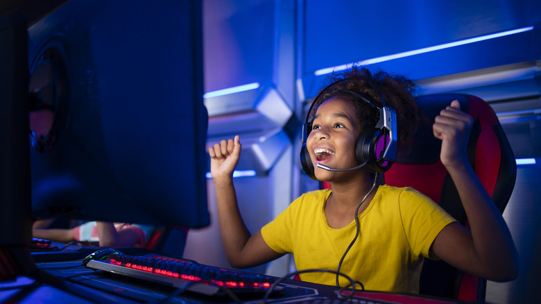 cute-young-girl-feeling-happy-and-excited-for-winning-computer-video-game